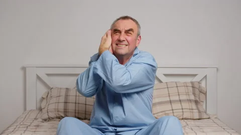 An elderly man in bed suffers from severe pain. Home sickness concept Stock Footage 167213661
