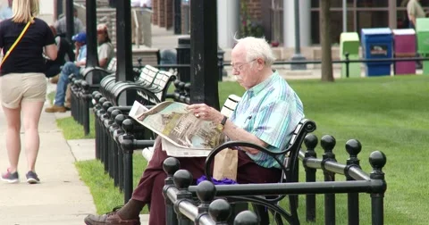 Elderly Man on Bench Reading Paper - 4k Stock Footage 51773662