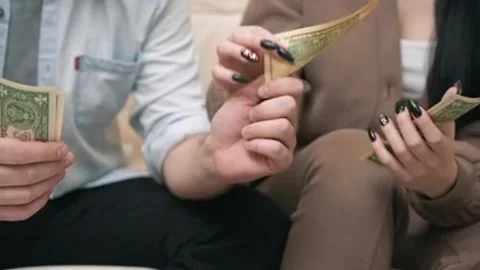 An elderly man carefully counts small dollar bills Stock Footage 293167325