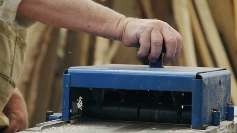 Elderly man carpenter builds a small boat with his hands out of wood in a small 스톡 동영상 89785279