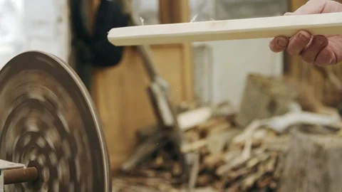 Elderly man carpenter builds a small boat with his hands out of wood in a small 스톡 동영상 89787573