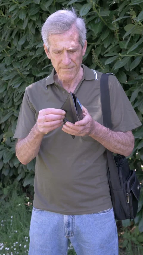 Elderly man checking empty wallet showing lack of money and poverty Stock Footage 333195188