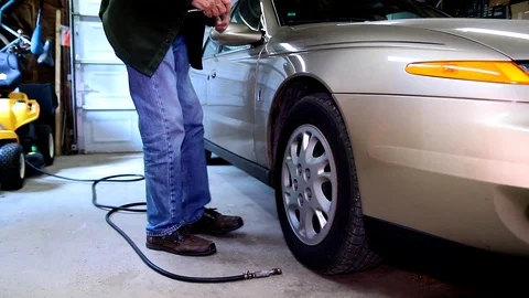 Elderly Man Checking Tire Air Pressure Video stock 95922903