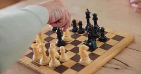 Elderly man, chess and board with hand on knight for contest, problem solving or Stock Footage 271126692