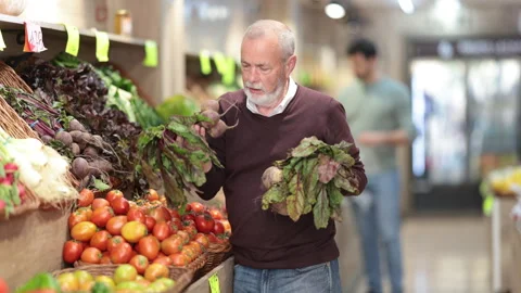 Elderly man chooses beets in vegetable shop Stock Footage 341429022
