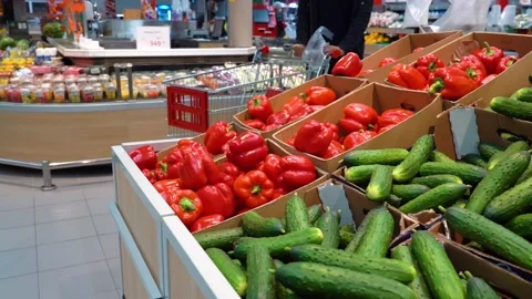 Elderly man chooses vegetables in the store Stock Footage 133781428