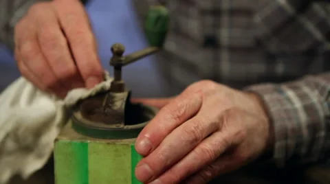 Elderly man cleaning a coffee mill. Close up. Video stock 45177643