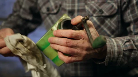Elderly man cleaning a coffee mill. Close up. Video stock 45178890