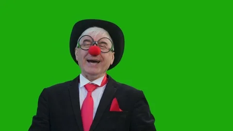 An elderly man in a clown costume laughs, and then takes off his suit and is sad Stock Footage 252245240