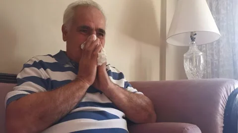 Elderly Man With a Cold Blowing Her Nose With a Handkerchief Stock Footage 142631231