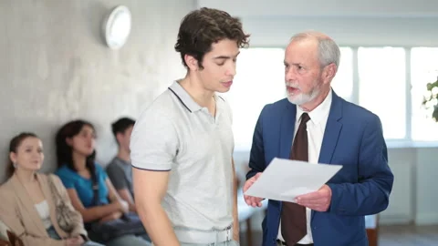 Elderly man communicates with a guy, they discuss documents and an interview Stock Footage 335618096