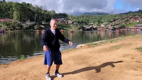 Elderly man doing exercise in park.  Aging lifestyle for good health concept. Stock Footage 228664677