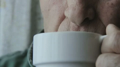 Elderly man drinking a cup of hot coffee Stock Footage 48058622