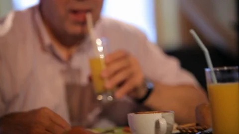 Elderly man drinking juice Stock Footage 100239423