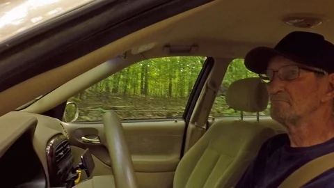 Elderly Man Driving Through The Forest 動画素材 87192582