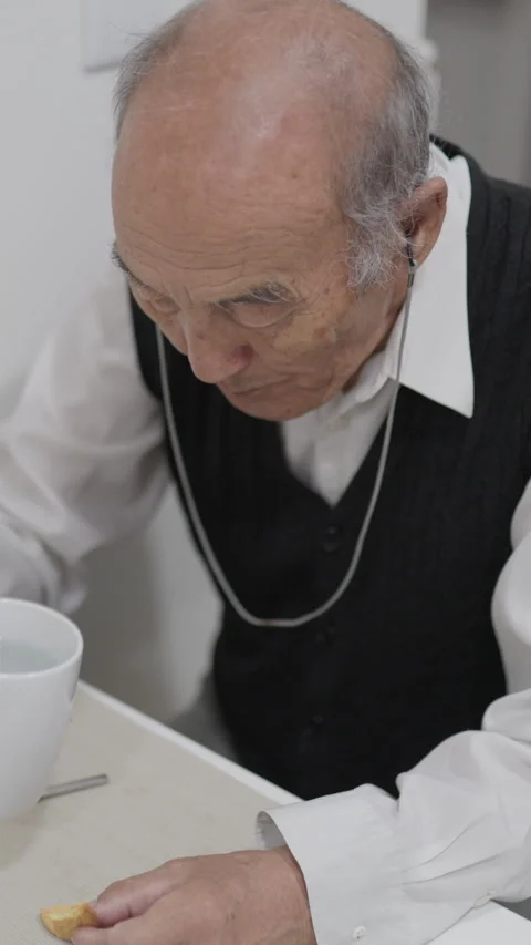 Elderly man enjoying breakfast with tea and biscuits Stock Footage 327230912