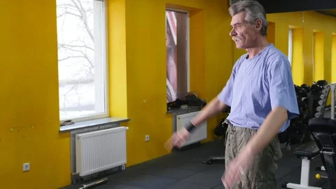 Elderly man exercising in gym Stock Footage 86864545
