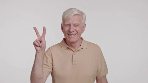 The elderly man flashed a happy peace sign gesture with his fingers Stock Footage 266922090