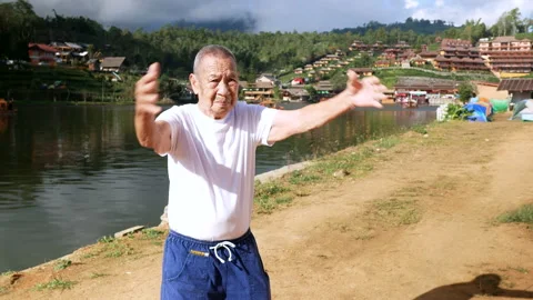 Elderly man with freckled face  doing exercise. Aging lifestyle concept. Stock Footage 228782913
