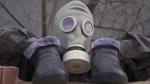 An elderly man in a gasmask. hands instead of feet. rubber shoes. freak. Stock Footage 130523537