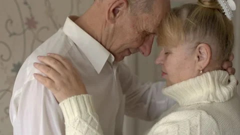 An elderly man gently embraces his beloved woman, congratulations on Valentine's Stock-Footage 145451409
