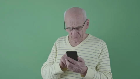 Elderly man with glasses concentrating on using smartphone Stock Footage 282672230