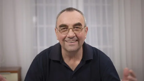 An elderly man with glasses smiles. On face smile joy and happiness Stock Footage 106207035
