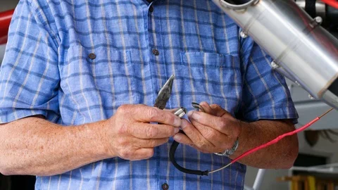 Elderly man in glasses is using plumbers to fix the wire 스톡 동영상 116773732