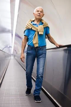 Elderly man going down to subway station Stock Photos