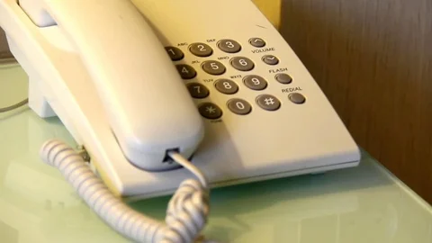 Elderly man hand dials the number on the old phone Stock Footage