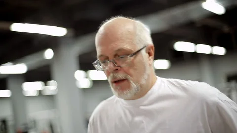 Elderly man has a treadmill Stock Footage 99790554