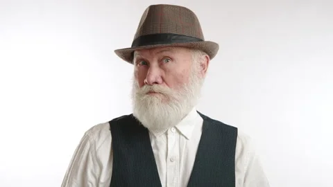 Elderly Man in Hat with Surprised Expression on White Stock Footage 263300513