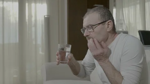 Elderly man having terrible sensitive toothache while he drink cold water Stock Footage 88400177