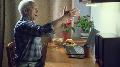 Elderly man having video chat making video call on webcam using a laptop at home Stock Footage 130378694