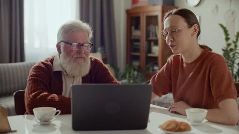 Elderly Man Learning How to Use Internet on Laptop with Help of Daughter Stock Footage 305722737