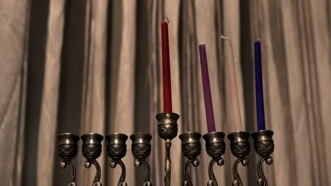 Elderly man lights candles on the thid day of the Jewish holiday Hanukkah Video stock 85579892