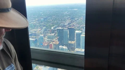 Elderly man looking out of elevator in Toronto, Canada Stock Footage 103319976