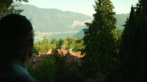 Elderly man looking out over lake in Switzerland Stock Footage 11880535