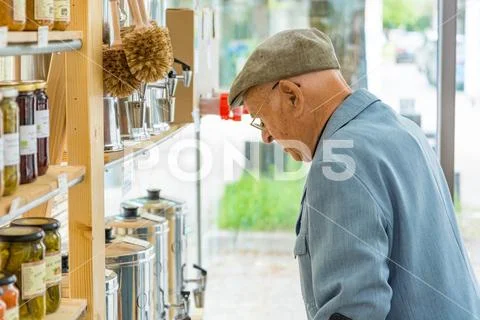 Elderly man looking at products at local organic zero waste store. Stock Photos