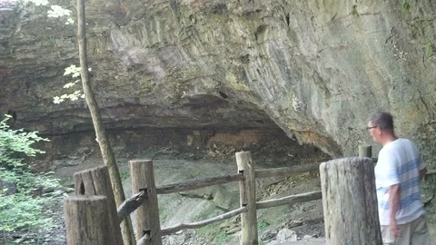 Elderly man looking at a small waterfalls 動画素材 111425449