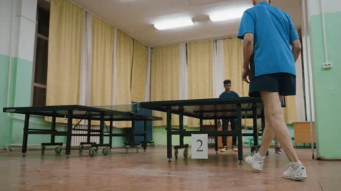 Elderly Man Lunges To Return Table Tennis Ball Against Young Opponents Stock Footage 319219065