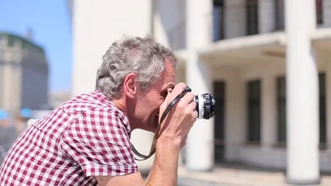 Elderly man makes a photo Stock Footage 75393780