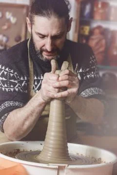 Elderly man making pot using pottery wheel in studio Stock Photos