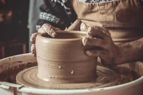Elderly man making pot using pottery wheel in studio Stock Photos