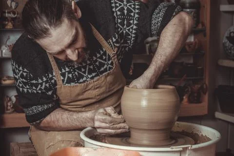 Elderly man making pot using pottery wheel in studio Stock Photos