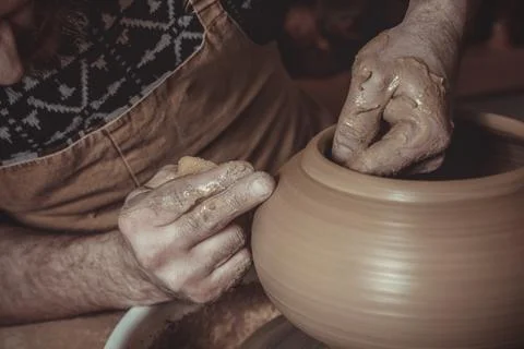 Elderly man making pot using pottery wheel in studio Stock Photos