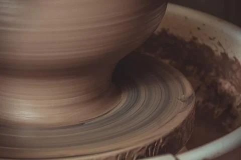 Elderly man making pot using pottery wheel in studio Stock Photos