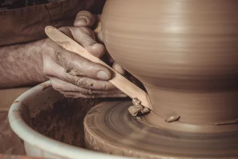 Elderly man making pot using pottery wheel in studio Stock Photos