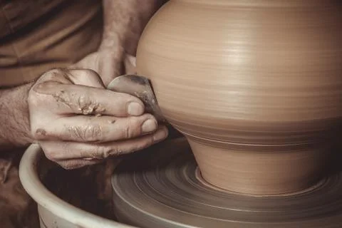 Elderly man making pot using pottery wheel in studio Stock Photos
