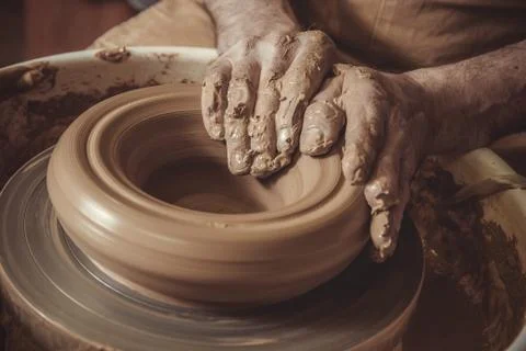 Elderly man making pot using pottery wheel in studio Stock Photos